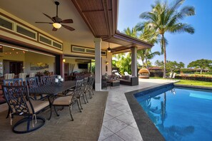 The swimming pool is conveniently located next to the lanai.