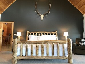 Stunning master bedroom with hand-hewn log king size bed.