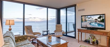 Living room looking out to the ocean through large floor to ceiling windows