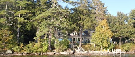 our house  from the lake, nestled in the trees, with great views of the water