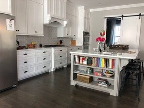 Kitchen with barn door into study area.