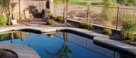 View of luxurious Pebble Tec pool from the patio and grill area