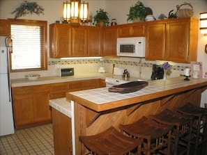 Fully-Equipped Kitchen w/ Range, Oven, Microwave, & Dishwasher. Laundry adjacent