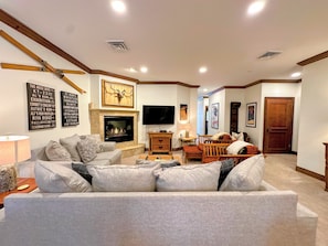 There's plenty of cozy seating around the fireplace and TV.