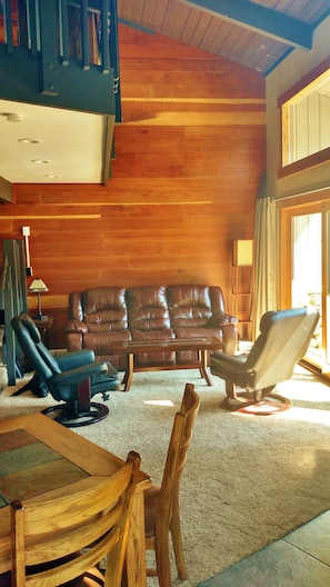Power Recliner Leather Couch faces 48" TV and Fire Stove, afternoon sunshine