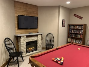 Electric fireplace in game room keeps everyone warm.
