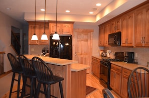 Well equipped kitchen with granite counter tops.