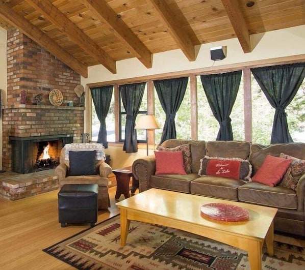Enjoy the warmth of the gas fireplace in this inviting living room with an open floor plan and a TV for family movie nights