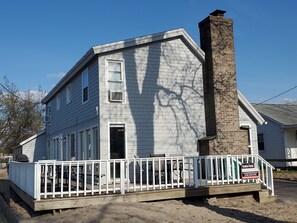 Large deck with lake view, tables & chairs for 16, and gas grill