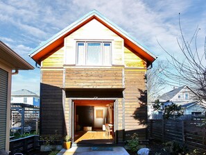 the  two-story cottage is entered through landscaped courtyard 