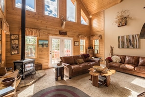 The living room has a fireplace, wood stove, and sound system.