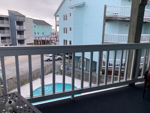 View from living room balcony overlooking the pool.  High Tide restaurant and ba