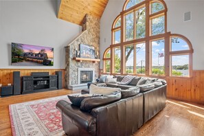 Great room overlooking Lake Winnipesauke w/fireplace, 85" tv and sound system.