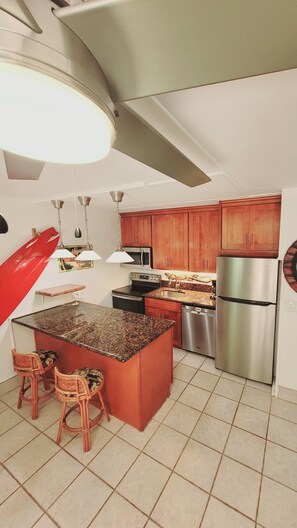 Renovated kitchen with large ceiling fan.