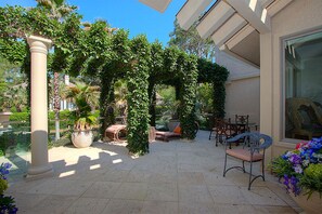 Sunset side atrium with chaise, tables/chairs.  A great get away spot.