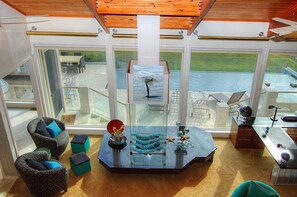 Decorative fireplace, large entertainment center, coastal art throughout