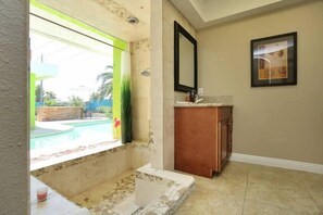 Master shower over looking back yard soon to be water wall over window. 