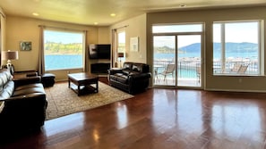 Large open living room on the main floor with multiple windows and views out to Lake Chelan