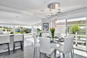 Dining area is located right next to the outdoor deck with BBQ