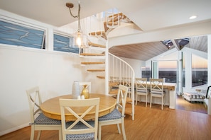 Dining area with spiral staircase to roof top.  table can be expanded to seat 6