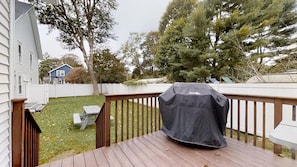 Back yard area off deck with grill.