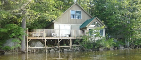 The cottage is 2 feet from the lake shore with the deck extending into the water