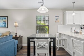 Dining area. Pub table with 4 chairs or split with peninsula for more space.