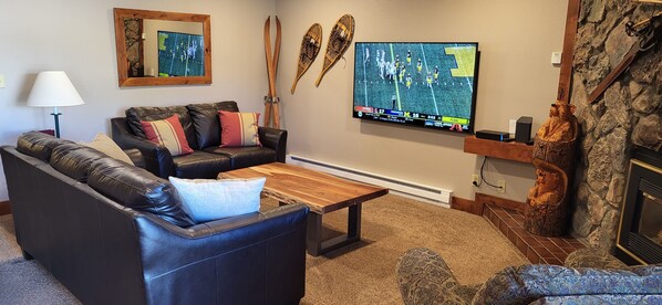 Living room with 65 inch TV and Fireplace