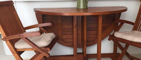 The Teak Dining Room table unfolds to seat 4 guests.
