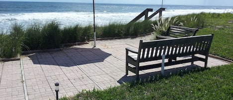 Enjoy the patio overlooking the beach, just a few steps to the sand below!