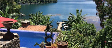 view of pool & lake from upper terrace