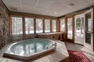 Private hot tub in the unit (seats 6). Easy access to lifts through patio door.
