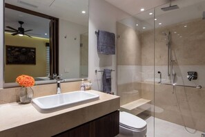Walk-in shower, with rain head and hand-held shower.