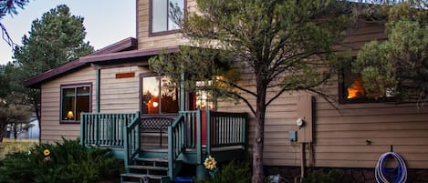 Front of our home surrounded by pinion pines.