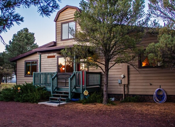 Front of our home surrounded by pinion pines.