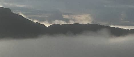 Peak of grandfather mountain surrounded by clouds from balcony