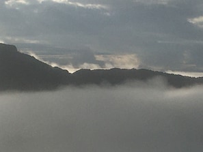 Peak of grandfather mountain surrounded by clouds from balcony