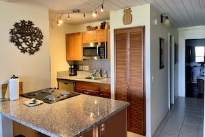 Modern kitchen with granite top. Washer/dryer in the closet. Fridge not shown.