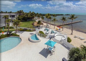 Beach, spa, pool, summer kitchen and day dock view.
