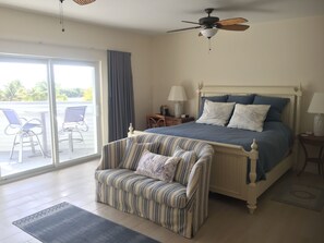 Master bedroom with walk-in closet and balcony overlooking the pool and beach.
