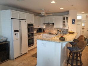 Granite kitchen with high end appliances and wine cooler.