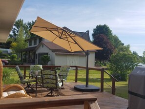 Deck with collapsible sun umbrella