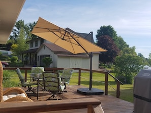 Deck with collapsible sun umbrella