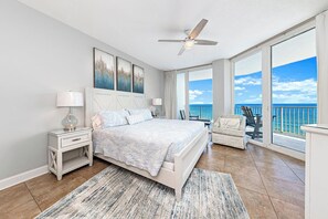 Spacious primary bedroom w/king bed, smart TV, and direct balcony access.