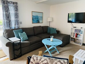 Living room with large couch, YouTube TV, Smart TV
