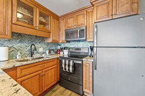 UPGRADED KITCHEN WITH NEW CABINETS, GRANITE COUNTER TOPS, & S/S APPLIANCES. 