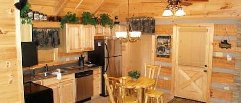 Fully stocked kitchen with log dining..