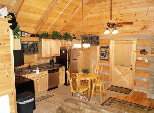 Fully stocked kitchen with log dining..