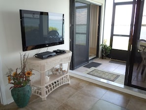 NEW flat screen TV and tiled floor throughout common living area.