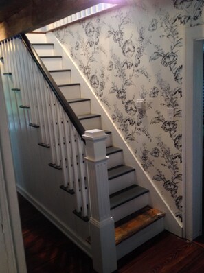 Ground staircase leads up to two bedrooms and bath.